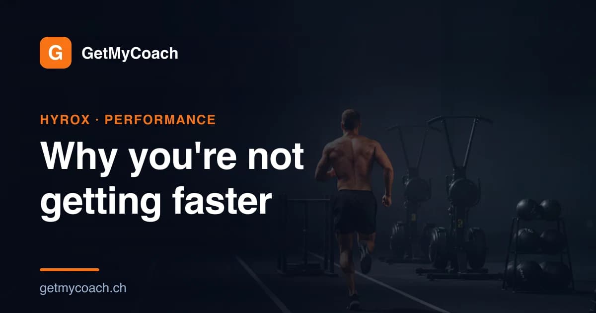 A lone athlete running past a row of empty functional-fitness stations in a dim indoor arena — cover image for the GetMyCoach guide to breaking a Hyrox plateau.