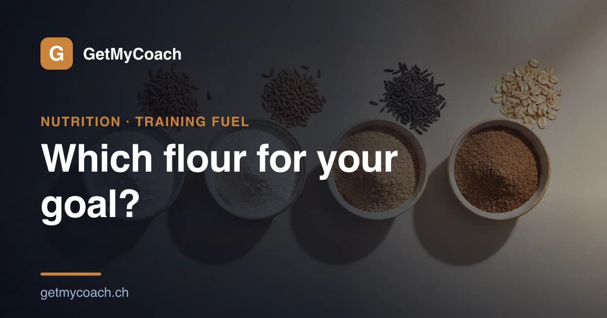 Four bowls of flour from very light to dark beside loose wheat, spelt, rye and oat grains — cover graphic for the GetMyCoach guide to choosing flour for your training goal.